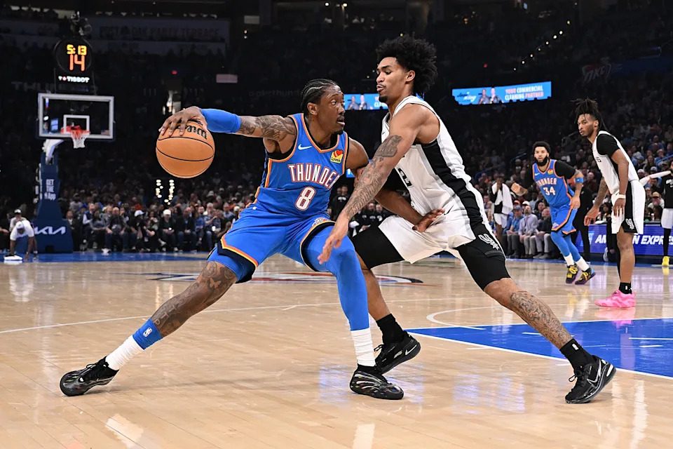 OKLAHOMA CITY, OKLAHOMA - JANUARY 13: Jalen Williams #8 of the Oklahoma City Thunder handles the ball as he is defended by Dylan Harper #2 of the San Antonio Spurs during the first half at Paycom Center on January 13, 2026 in Oklahoma City, Oklahoma. NOTE TO USER: User expressly acknowledges and agrees that, by downloading and or using this photograph, User is consenting to the terms and conditions of the Getty Images License Agreement. (Photo by Joshua Gateley/Getty Images)