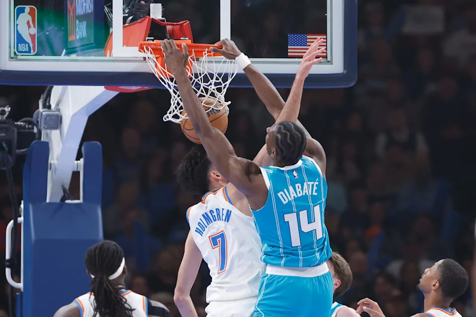 Jan 5, 2026; Oklahoma City, Oklahoma, USA; Charlotte Hornets forward Moussa Diabate (14) dunks over Oklahoma City Thunder center Chet Holmgren (7) during the first quarter at Paycom Center. Mandatory Credit: Alonzo Adams-Imagn Images