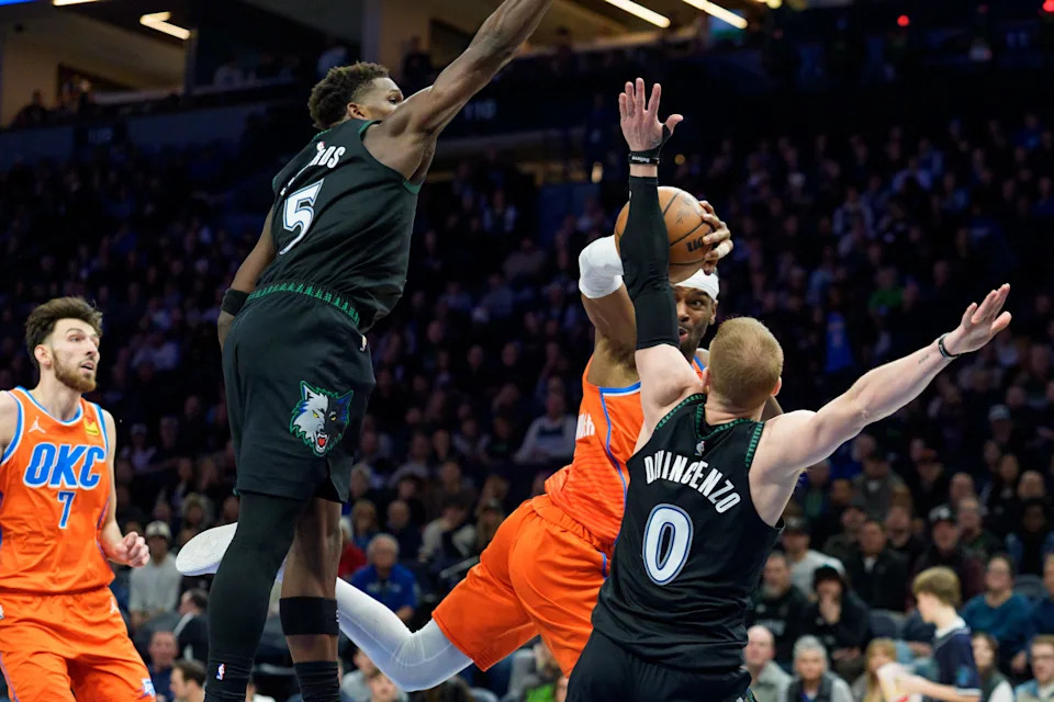 Jan 29, 2026; Minneapolis, Minnesota, USA; Oklahoma City Thunder guard Shai Gilgeous-Alexander (2) is fouled by Minnesota Timberwolves guard Donte DiVincenzo (0) and guard Anthony Edwards (5) in the third quarter at Target Center. Mandatory Credit: Matt Blewett-Imagn Images