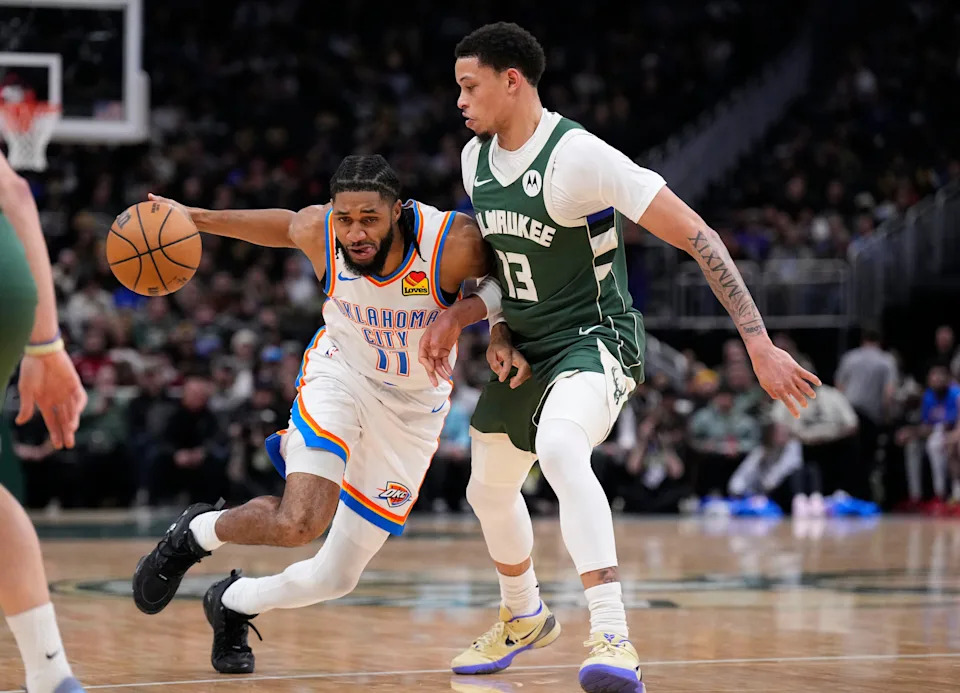 Jan 21, 2026; Milwaukee, Wisconsin, USA; Oklahoma City Thunder guard Isaiah Joe (11) drives to the basket against Milwaukee Bucks guard Ryan Rollins (13) in the first half at Fiserv Forum. Mandatory Credit: Michael McLoone-Imagn Images