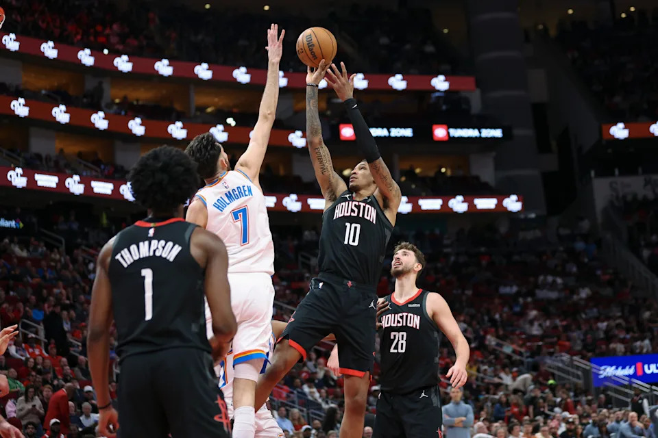 Jan 15, 2026; Houston, Texas, USA; Houston Rockets forward Jabari Smith Jr. (10) shoots the ball as Oklahoma City Thunder center Chet Holmgren (7) defends during the second quarter at Toyota Center. Mandatory Credit: Troy Taormina-Imagn Images