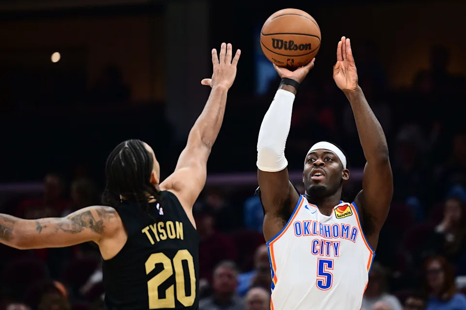 Jan 19, 2026; Cleveland, Ohio, USA; Oklahoma City Thunder guard Luguentz Dort (5) shoots over the defense of Cleveland Cavaliers guard Jaylon Tyson (20) during the first half at Rocket Arena. Mandatory Credit: Ken Blaze-Imagn Images