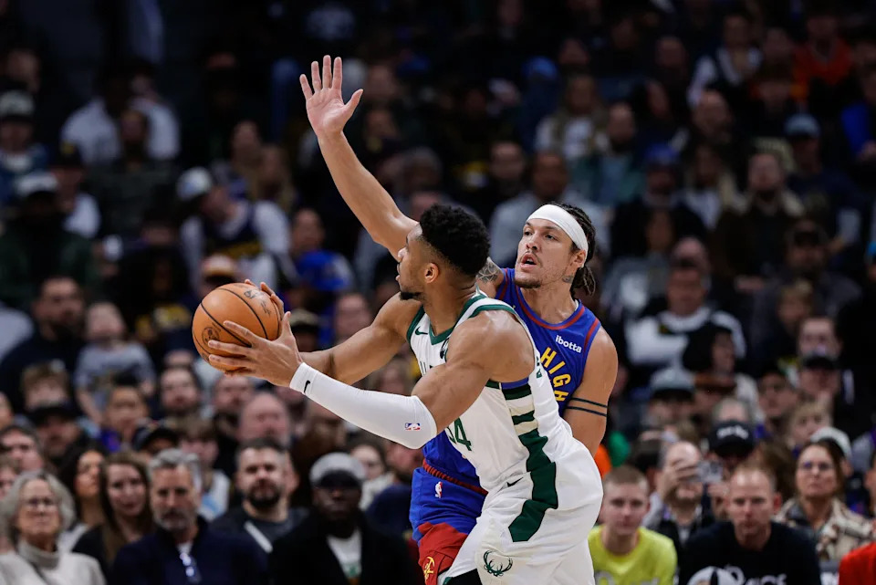 Bucks forward Giannis Antetokounmpo lines up a shot while being guarded by Nuggets forward Aaron Gordon during the first quarter on Sunday, Jan. 11 at Ball Arena in Denver.