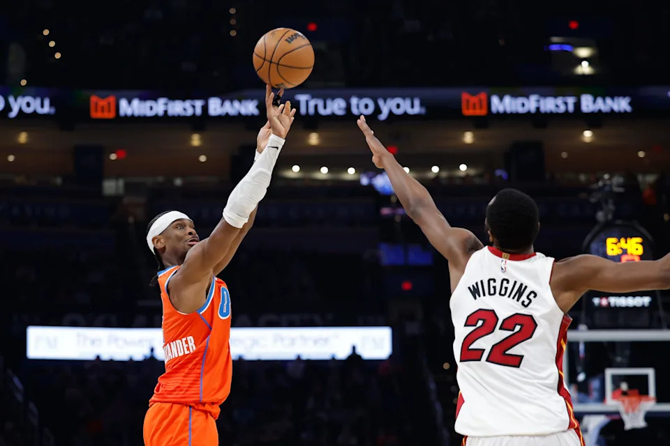 Jan 11, 2026; Oklahoma City, Oklahoma, USA; Oklahoma City Thunder guard Shai Gilgeous-Alexander (2) shoots over Miami Heat forward Andrew Wiggins (22) during the second half at Paycom Center. Mandatory Credit: Alonzo Adams-Imagn Images