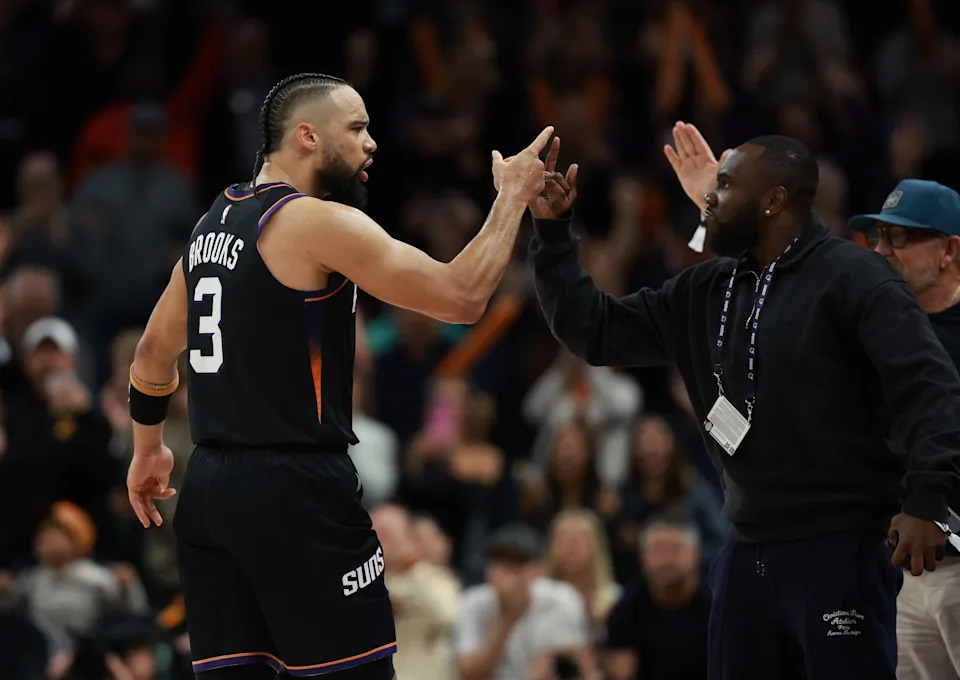 Jan 4, 2026; Phoenix, Arizona, USA; Phoenix Suns forward Dillon Brooks (3) celebrates a three point shot with a fan court side against the Oklahoma City Thunder in the second half at Mortgage Matchup Center. Mandatory Credit: Mark J. Rebilas-Imagn Images