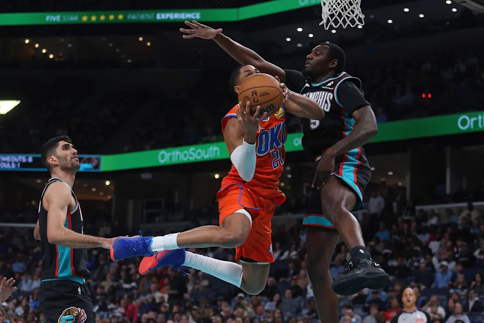Jan 9, 2026; Memphis, Tennessee, USA; Oklahoma City Thunder guard Aaron Wiggins (21) drives to the basket as Memphis Grizzlies forward Vince Williams Jr. (5) defends during the second quarter at FedExForum. Mandatory Credit: Petre Thomas-Imagn Images