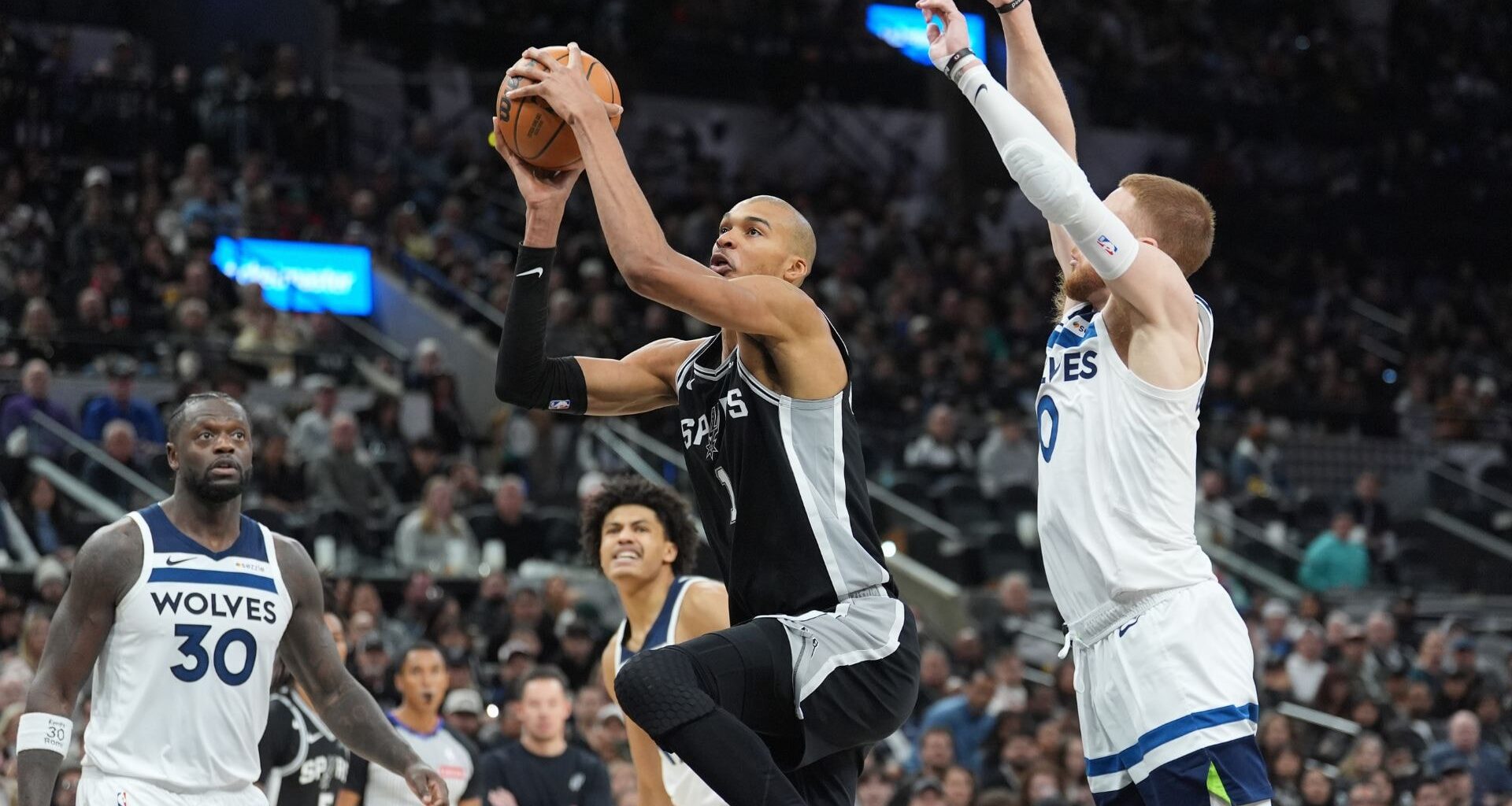 Dec 25, 2025; Oklahoma City, Oklahoma, USA; San Antonio Spurs forward Victor Wembanyama (1) drives down the court beside Oklahoma City Thunder guard Jalen Williams (8) during the second quarter at Paycom Center