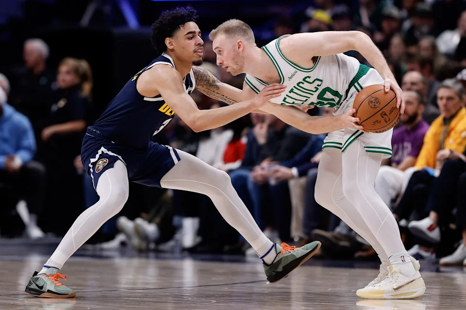 Jan 7, 2025; Denver, Colorado, USA; Boston Celtics forward Sam Hauser (30) controls the ball as Denver Nuggets guard Julian Strawther (3) guards in the second quarter at Ball Arena. Mandatory Credit: Isaiah J. Downing-Imagn Images