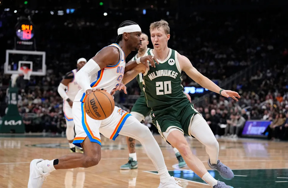 Jan 21, 2026; Milwaukee, Wisconsin, USA; Oklahoma City Thunder guard Shai Gilgeous-Alexander (2) drives to the basket against Milwaukee Bucks guard AJ Green (20) in the first half at Fiserv Forum. Mandatory Credit: Michael McLoone-Imagn Images