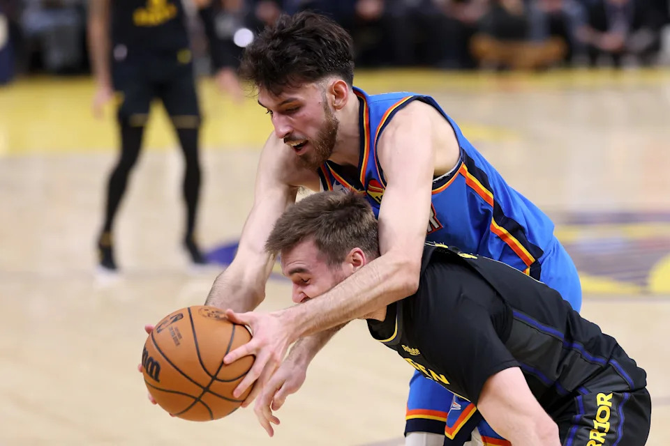 SAN FRANCISCO, CALIFORNIA - JANUARY 02: Chet Holmgren #7 of the Oklahoma City Thunder and Pat Spencer #61 of the Golden State Warriors go for a loose ball during the first half at Chase Center on January 02, 2026 in San Francisco, California. NOTE TO USER: User expressly acknowledges and agrees that, by downloading and/or using this photograph, user is consenting to the terms and conditions of the Getty Images License Agreement. (Photo by Ezra Shaw/Getty Images)