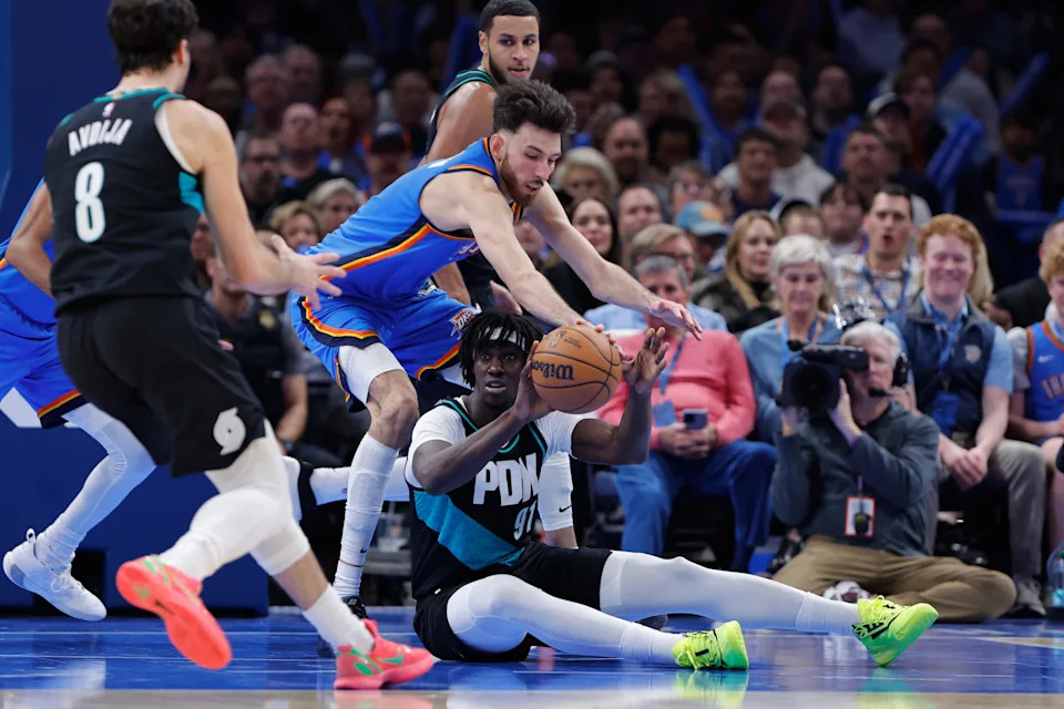 Dec 31, 2025; Oklahoma City, Oklahoma, USA; Oklahoma City Thunder center Chet Holmgren (7) and Portland Trail Blazers guard Sidy Cissoko (91) reach for a loose ball during the second half at Paycom Center. Mandatory Credit: Alonzo Adams-Imagn Images