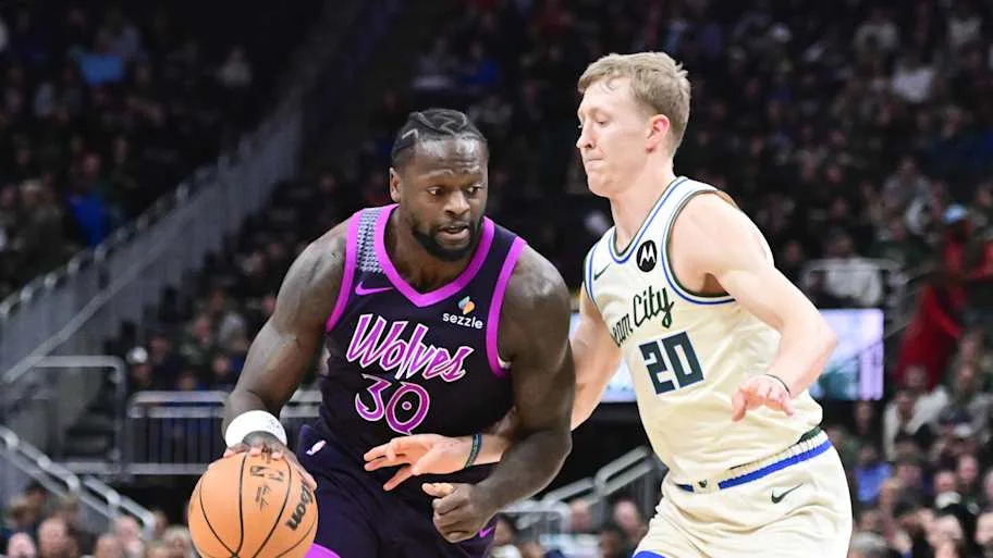 Minnesota Timberwolves forward Julius Randle drives for the basket against Milwaukee Bucks guard AJ Green
