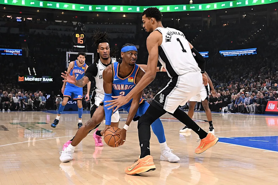 OKLAHOMA CITY, OKLAHOMA - JANUARY 13: Shai Gilgeous-Alexander #2 of the Oklahoma City Thunder handles the ball in front of Victor Wembanyama #1 of the San Antonio Spurs during the first half at Paycom Center on January 13, 2026 in Oklahoma City, Oklahoma. NOTE TO USER: User expressly acknowledges and agrees that, by downloading and or using this photograph, User is consenting to the terms and conditions of the Getty Images License Agreement. (Photo by Joshua Gateley/Getty Images)