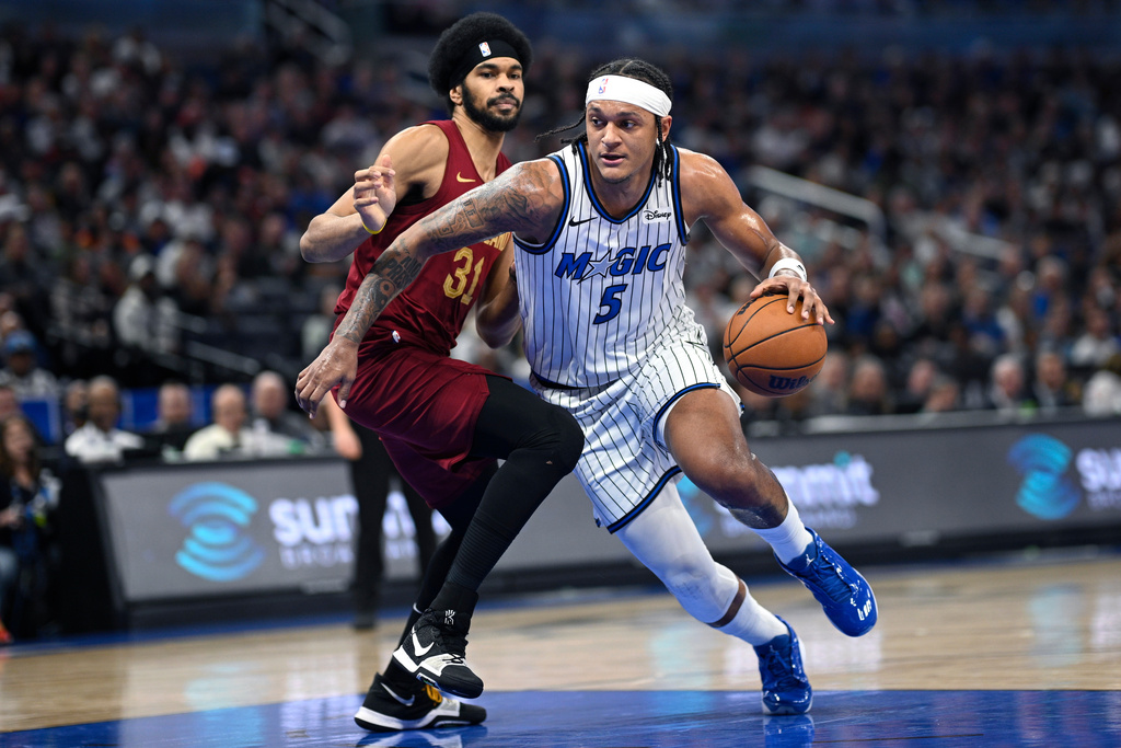 Orlando Magic forward Paolo Banchero (5) drives to the basket as Cleveland Cavaliers center Jarrett Allen (31) defends during the first half of an NBA basketball game, Saturday, Jan. 24, 2026, in Orlando, Fla. (AP Photo/Phelan M. Ebenhack)