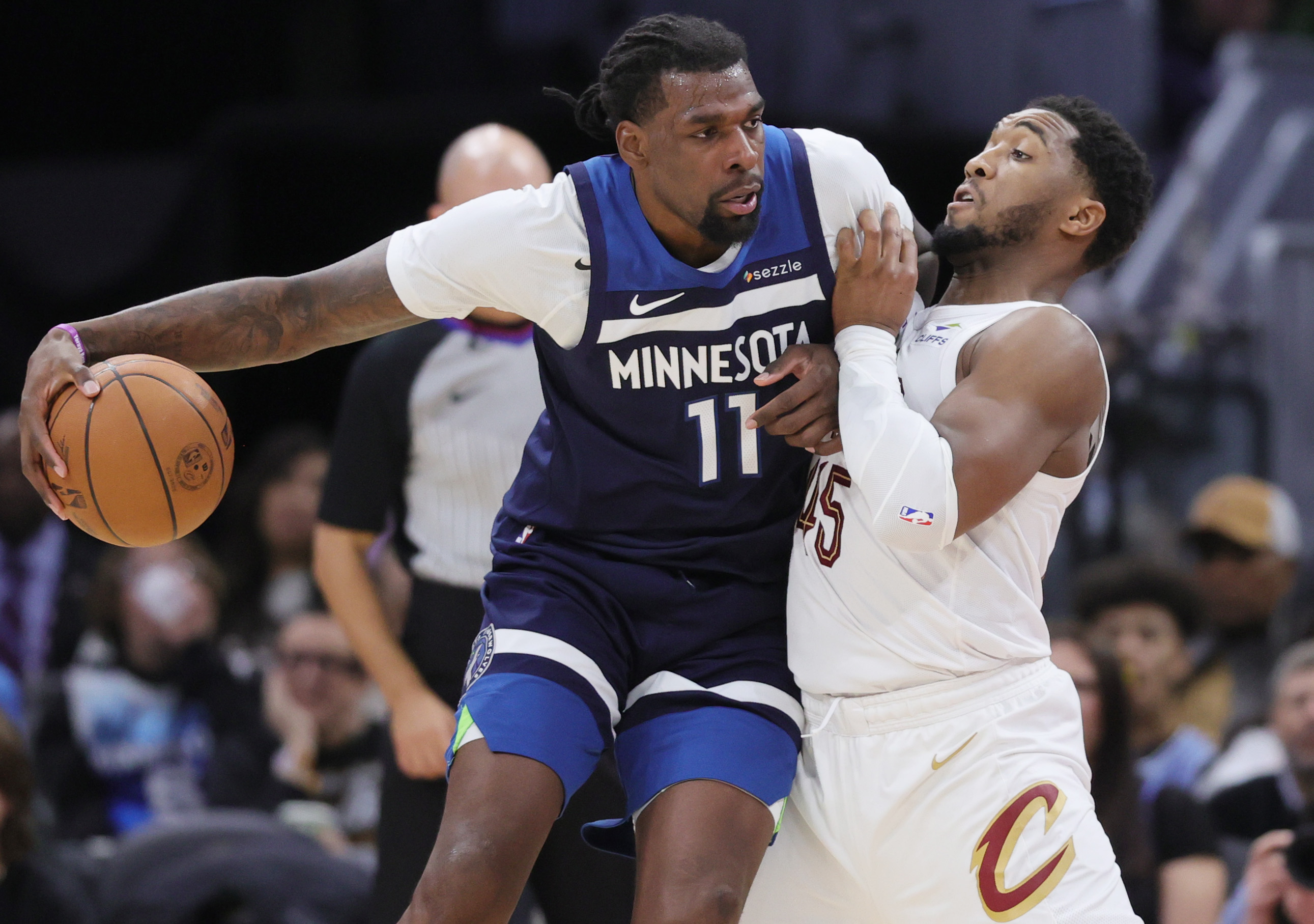 Minnesota Timberwolves center Naz Reid bangs into the defense of Cleveland Cavaliers guard Donovan Mitchell in the second half. 