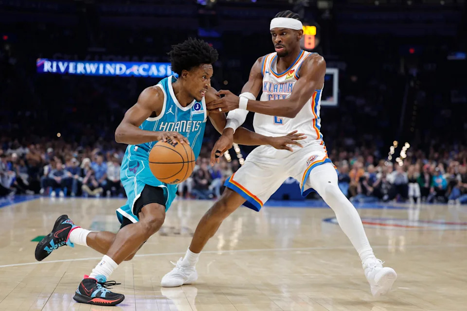 Jan 5, 2026; Oklahoma City, Oklahoma, USA; Charlotte Hornets guard Collin Sexton (8) drives around Oklahoma City Thunder guard Shai Gilgeous-Alexander (2) during the second half at Paycom Center. Mandatory Credit: Alonzo Adams-Imagn Images