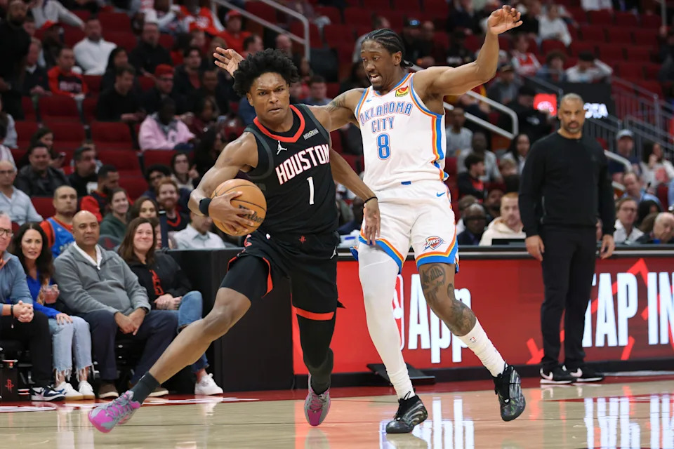 Jan 15, 2026; Houston, Texas, USA; Houston Rockets guard Amen Thompson (1) controls the ball as Oklahoma City Thunder guard Jalen Williams (8) defends during the first quarter at Toyota Center. Mandatory Credit: Troy Taormina-Imagn Images
