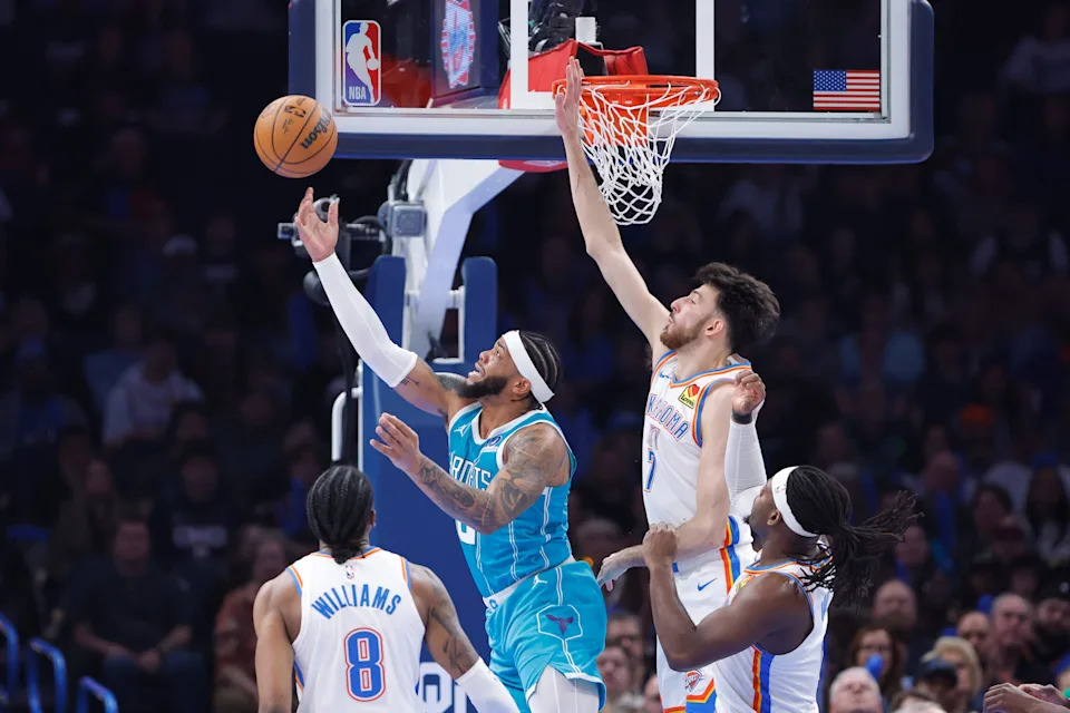 Jan 5, 2026; Oklahoma City, Oklahoma, USA; Charlotte Hornets forward Miles Bridges (0) shoots from under the basket in front of Oklahoma City Thunder center Chet Holmgren (7) during the second quarter at Paycom Center. Mandatory Credit: Alonzo Adams-Imagn Images