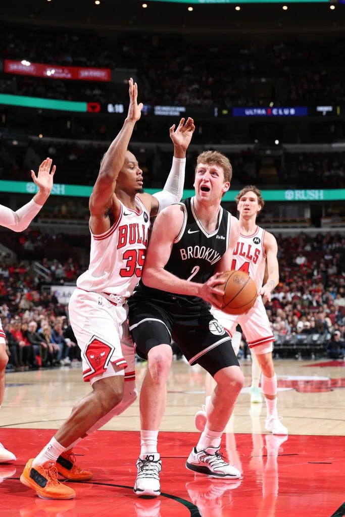 Danny Wolf of the Brooklyn Nets drives to the basket as Issac Okoro of the Chicago Bulls plays defense during the game on January 18, 2026 at United Center in Chicago, Illinois. NBAE via Getty Images