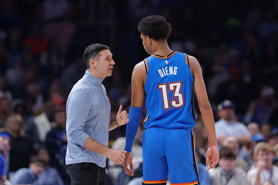 Nov 23, 2025; Oklahoma City, Oklahoma, USA; Oklahoma City Thunder head coach Mark Daigneault talks to forward Ousmane Dieng (13) during the second quarter at Paycom Center. Mandatory Credit: Alonzo Adams-Imagn Images