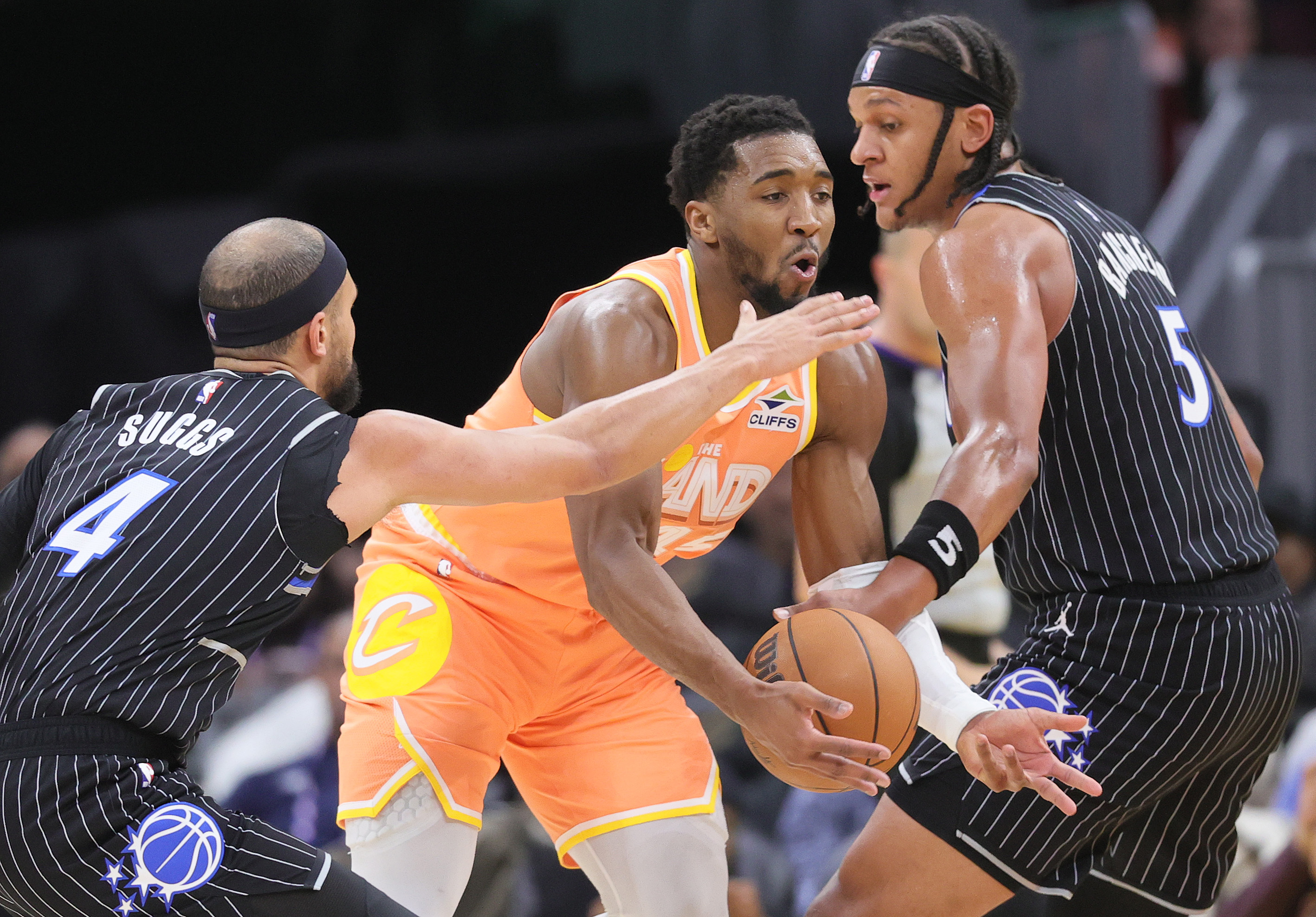 Cleveland Cavaliers guard Donovan Mitchell drives between the defense of Orlando Magic guard Jalen Suggs (L) and Orlando Magic forward Paolo Banchero in the second half. 