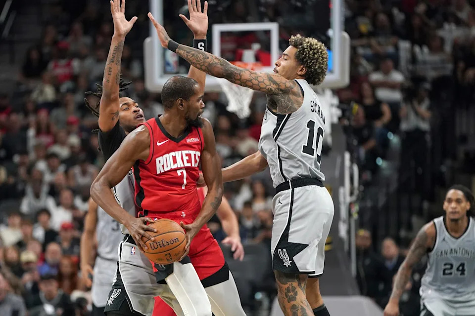 Nov 7, 2025; San Antonio, Texas, USA; San Antonio Spurs guard Stephon Castle (5) and forward Jeremy Sochan (10) guard Houston Rockets forward Kevin Durant (7) during the second half at Frost Bank Center. Mandatory Credit: Dustin Safranek-Imagn Images