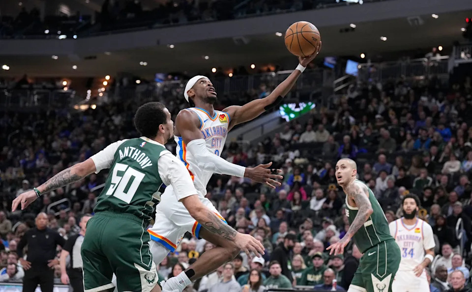 Jan 21, 2026; Milwaukee, Wisconsin, USA; Oklahoma City Thunder guard Shai Gilgeous-Alexander (2) drives to the basket against Milwaukee Bucks guard Cole Anthony (50) and m18/ in the first half at Fiserv Forum. Mandatory Credit: Michael McLoone-Imagn Images