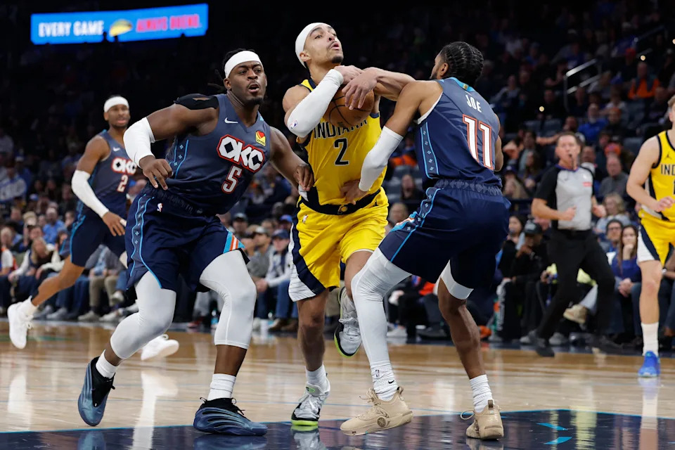 Jan 23, 2026; Oklahoma City, Oklahoma, USA; Indiana Pacers guard/forward Andrew Nembhard (2) drives between Oklahoma City Thunder guard Luguentz Dort (5) and guard Isaiah Joe (11) during the second half at Paycom Center. Mandatory Credit: Alonzo Adams-Imagn Images