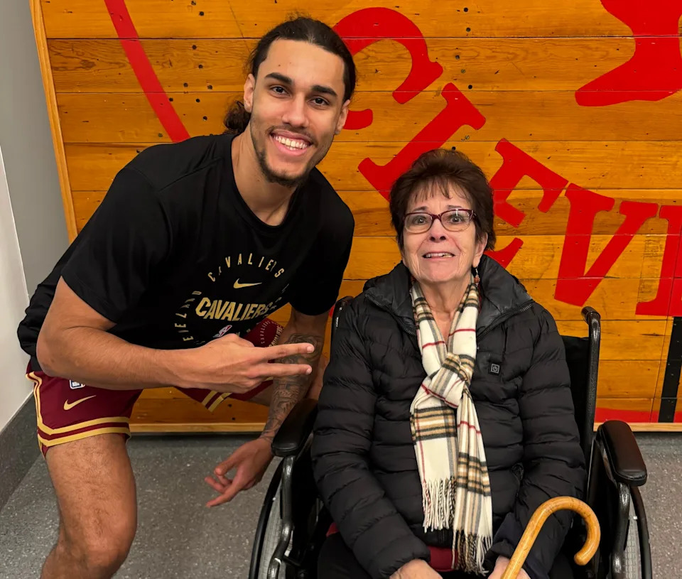 Cleveland Cavaliers player Jaylon Tyson poses for a photograph with Cavs fan Janet Ulrich during the 2024-25 NBA season at Rocket Arena.