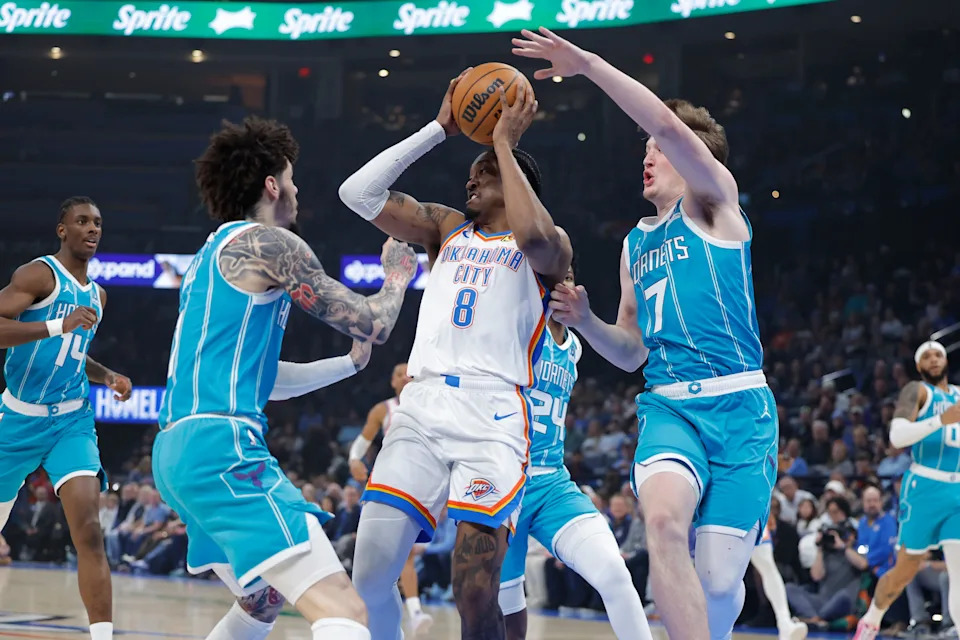 Jan 5, 2026; Oklahoma City, Oklahoma, USA; Oklahoma City Thunder guard Jalen Williams (8) passes between Charlotte Hornets guard Lamelo Ball (1) and guard Kon Knueppel (7) during the first quarter at Paycom Center. Mandatory Credit: Alonzo Adams-Imagn Images