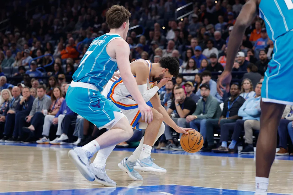Jan 5, 2026; Oklahoma City, Oklahoma, USA; Oklahoma City Thunder guard Ajay Mitchell (25) gets hit in the face on a drive beside Charlotte Hornets guard Kon Knueppel (7) during the second quarter at Paycom Center. Mandatory Credit: Alonzo Adams-Imagn Images