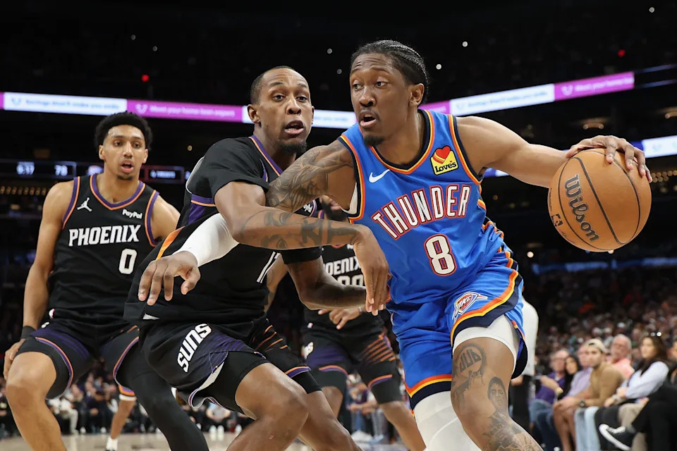 PHOENIX, ARIZONA - JANUARY 04: Jalen Williams #8 of the Oklahoma City Thunder handles the ball against Jamaree Bouyea #17 of the Phoenix Suns during the second half of the NBA game at Mortgage Matchup Center on January 04, 2026 in Phoenix, Arizona. The Suns defeated the Thunder 108-105. NOTE TO USER: User expressly acknowledges and agrees that, by downloading and or using this photograph, user is consenting to the terms and conditions of the Getty Images License Agreement. (Photo by Christian Petersen/Getty Images)