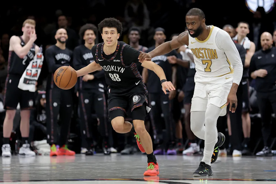 Jan 23, 2026; Brooklyn, New York, USA; Brooklyn Nets guard Nolan Traore (88) brings the ball up court against Boston Celtics guard Jaylen Brown (7) during double overtime at Barclays Center. Mandatory Credit: Brad Penner-Imagn Images
