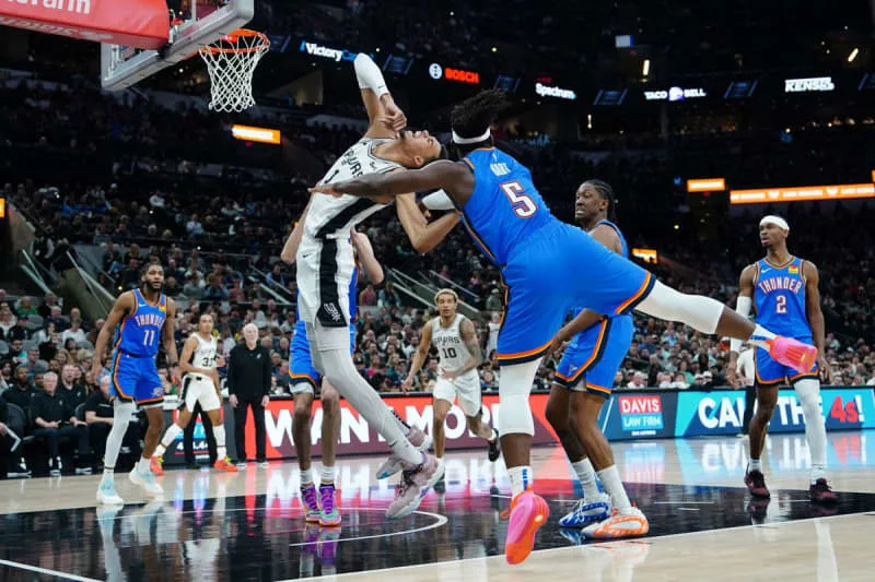 Feb 29, 2024; San Antonio, Texas, USA; Oklahoma City Thunder guard Luguentz Dort (5) could San Antonio Spurs center Victor Wembanyama (1) in the first half at Frost Bank Center. Mandatory Credit: Daniel Dunn-USA TODAY Sports