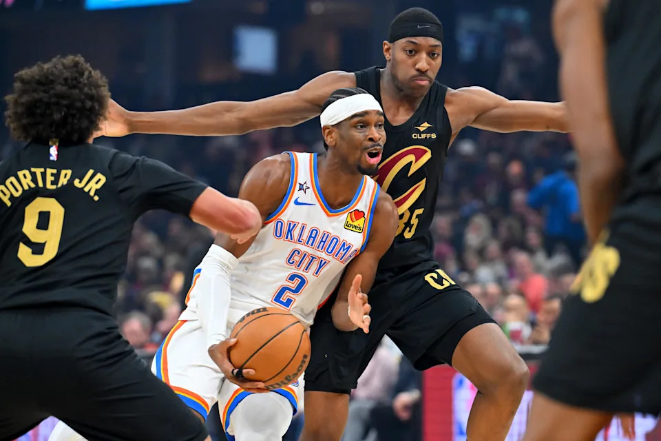 CLEVELAND, OHIO - JANUARY 19: Guard Shai Gilgeous-Alexander #2 of the Oklahoma City Thunder drives to the basket around guard Craig Porter Jr. #9 and forward Nae'qwan Tomlin #35 of the Cleveland Cavaliers during the first quarter at Rocket Arena on January 19, 2026 in Cleveland, Ohio. NOTE TO USER: User expressly acknowledges and agrees that, by downloading and or using this photograph, User is consenting to the terms and conditions of the Getty Images License Agreement. (Photo by Jason Miller/Getty Images)