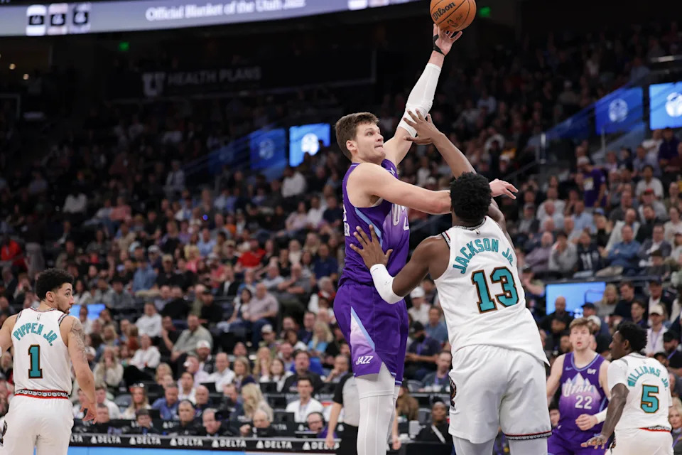 Mar 25, 2025; Salt Lake City, Utah, USA; Utah Jazz center Walker Kessler (24) shoots the ball over Memphis Grizzlies forward Jaren Jackson Jr. (13) during the second quarter at Delta Center. Mandatory Credit: Chris Nicoll-Imagn Images