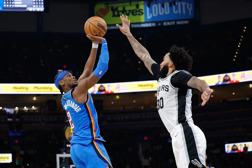 Jan 13, 2026; Oklahoma City, Oklahoma, USA; Oklahoma City Thunder guard Shai Gilgeous-Alexander (2) shoots and scores a basket as San Antonio Spurs forward Julian Champagnie (30) defends during the second half at Paycom Center. Mandatory Credit: Alonzo Adams-Imagn Images