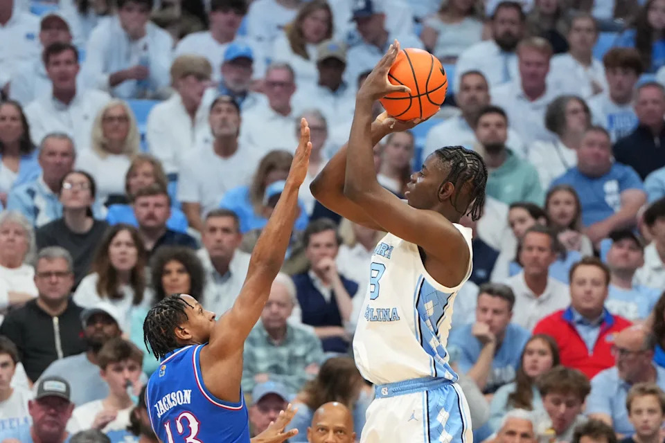 Nov 7, 2025; Chapel Hill, North Carolina, USA; North Carolina Tar Heels forward Caleb Wilson (8) shoots as Kansas Jayhawks guard Elmarko Jackson (13) defends in the first half at Dean E. Smith Center. Mandatory Credit: Bob Donnan-Imagn Images