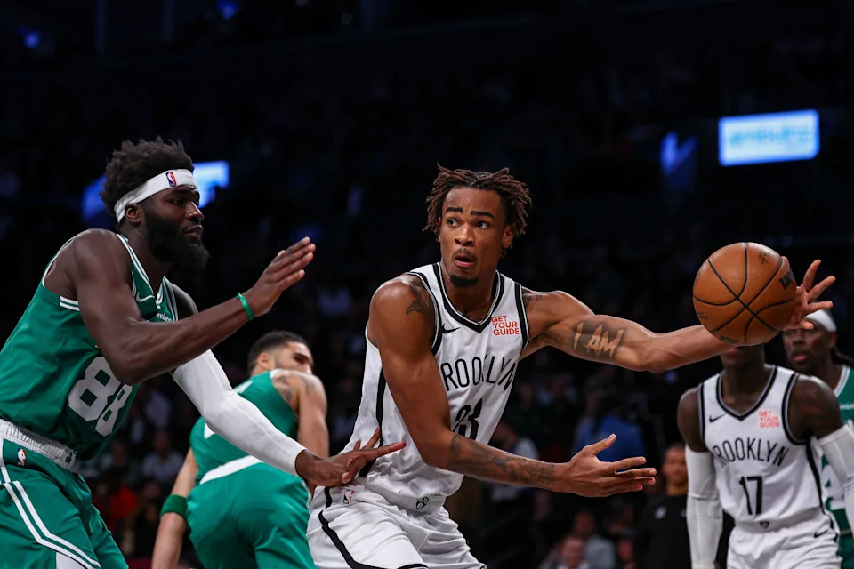 Nov 13, 2024; Brooklyn, New York, USA; Brooklyn Nets center Nic Claxton (33) passes the ball as Boston Celtics center Neemias Queta (88) defends during the second half at Barclays Center. Mandatory Credit: Vincent Carchietta-Imagn Images