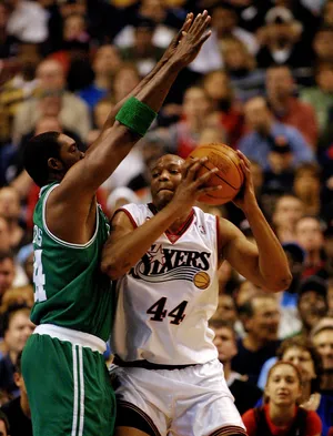 The Boston Celtics' Rodney Rogers (left) blocks the path of the Philadelphia 76ers' Derrick Coleman (right) in the 1st period of game 3 in the first round of the Eastern Conference playoffs on April 28, 2002, at the First Union Center in Philadelphia.