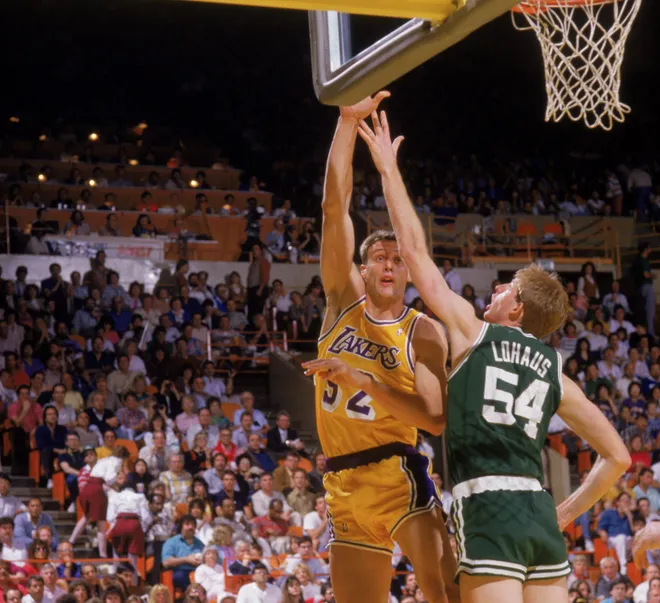 LOS ANGELES - 1987: Mike Smrek #52 of the Los Angeles Lakers shoots over Brad Lohaus #54 of the Boston Celtics during an NBA game at the Great Western Forum in Los Angeles, California in 1987. (Photo by: Rick Stewart/Getty Images)