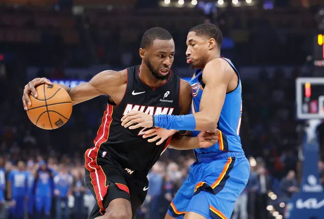 Feb 12, 2025; Oklahoma City, Oklahoma, USA; Miami Heat forward Andrew Wiggins (22) drives to the basket against Oklahoma City Thunder guard Aaron Wiggins (21) during the first quarter at Paycom Center. Mandatory Credit: Alonzo Adams-Imagn Images