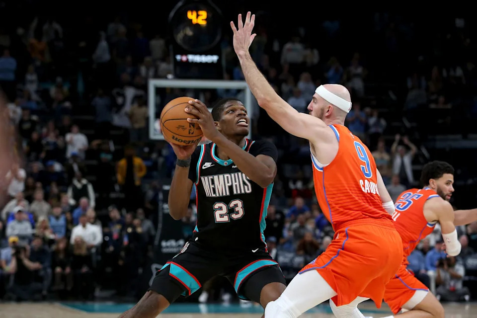 Jan 9, 2026; Memphis, Tennessee, USA; Memphis Grizzlies forward Cedric Coward (23) looks for an open shot in the final seconds of the the fourth quarter as Oklahoma City Thunder guard Alex Caruso (9) defends at FedExForum. Mandatory Credit: Petre Thomas-Imagn Images