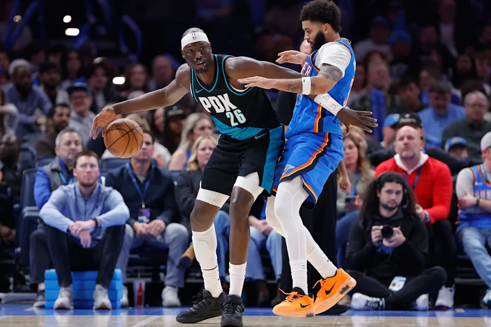 Dec 31, 2025; Oklahoma City, Oklahoma, USA;Portland Trail Blazers center Duop Reath (26) moves the ball as Oklahoma City Thunder guard Kenrich Williams (34) defends during the second half at Paycom Center. Mandatory Credit: Alonzo Adams-Imagn Images