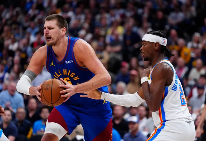 May 9, 2025; Denver, Colorado, USA; Oklahoma City Thunder guard Shai Gilgeous-Alexander (2) defends on Denver Nuggets center Nikola Jokic (15) in the second half during game three of the second round for the 2025 NBA Playoffs at Ball Arena. Mandatory Credit: Ron Chenoy-Imagn Images