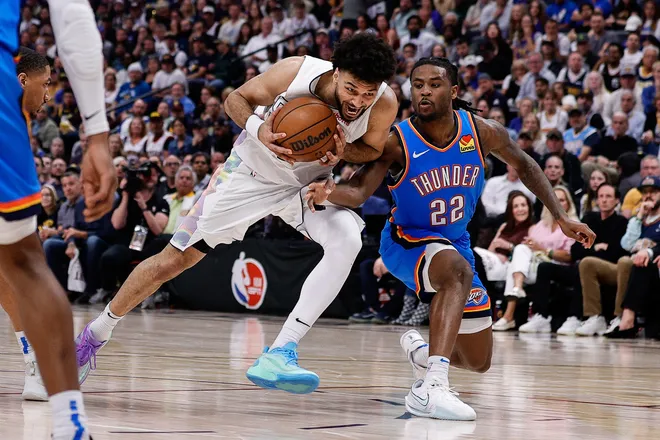May 15, 2025; Denver, Colorado, USA; Denver Nuggets guard Jamal Murray (27) drives to the net against Oklahoma City Thunder guard Cason Wallace (22) in the fourth quarter during game six of the second round for the 2025 NBA Playoffs at Ball Arena. Mandatory Credit: Isaiah J. Downing-Imagn Images