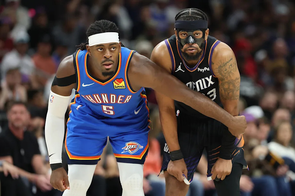 PHOENIX, ARIZONA - JANUARY 04: Luguentz Dort #5 of the Oklahoma City Thunder and Jordan Goodwin #23 of the Phoenix Suns line up during the first half of the NBA game at Mortgage Matchup Center on January 04, 2026 in Phoenix, Arizona. NOTE TO USER: User expressly acknowledges and agrees that, by downloading and or using this photograph, user is consenting to the terms and conditions of the Getty Images License Agreement. (Photo by Christian Petersen/Getty Images)