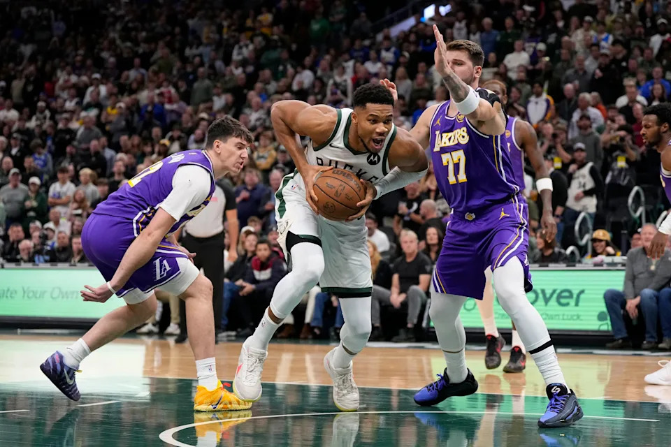 Nov 15, 2025; Milwaukee, Wisconsin, USA; Milwaukee Bucks forward Giannis Antetokounmpo (34) drives for the basket against Los Angeles Lakers guard Luka Doncic (77) during the first quarter at Fiserv Forum. Mandatory Credit: Jeff Hanisch-Imagn Images