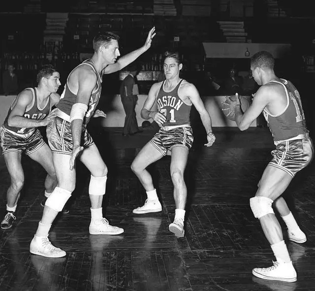 The 1953–54 Boston Celtics basketball team practicing the pick and roll. From left to rightː Bob Donham, Ed Mikan, Bill Sharman and Chuck Cooper