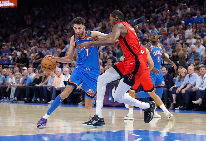 Oct 21, 2025; Oklahoma City, Oklahoma, USA; Oklahoma City Thunder center Chet Holmgren (7) moves the ball down the court as Houston Rockets forward Kevin Durant (7) defends during the first half at Paycom Center. Mandatory Credit: Alonzo Adams-Imagn Images